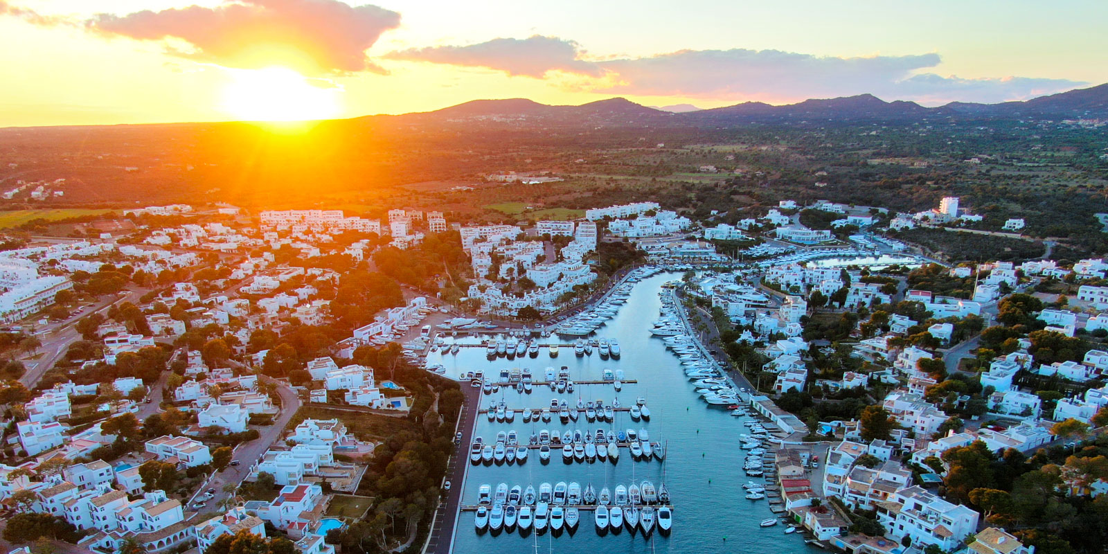 Aerial view of the marina of Cala d’Or, one of the places to visit as a couple at sunset in Mallorca.