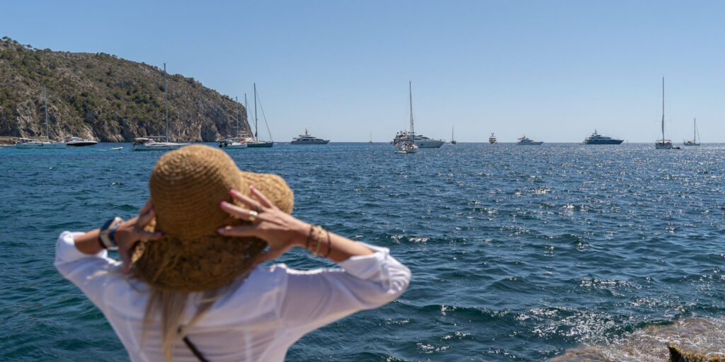Woman enjoying a sunny day by the sea in Mallorca to ask if there are sharks in Mallorca beaches