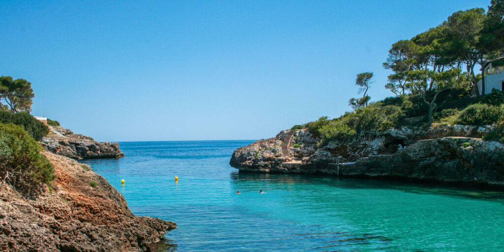 Cove in Cala d'Or, with pristine waters of the Mediterranean Sea, to find out what are the best areas in Mallorca for a family holiday